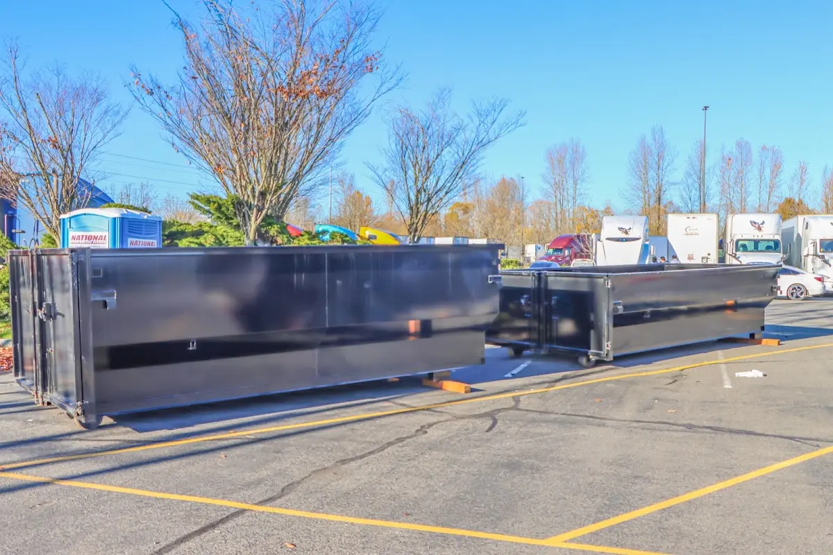 Professional dumpster rental service with roll-off container on residential driveway in Wichita